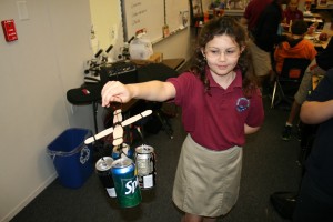 Fourth-grader Shea Herlily, 9, displays a mobile she made from soda cans. This is her first year at the school. At her previous school, she said, she was so bored she would cry. Now? "It's finally, really challenging."