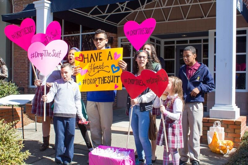 Students supporting "Operation Have a Heart" stand outside the Florida Education Association's headquarters.